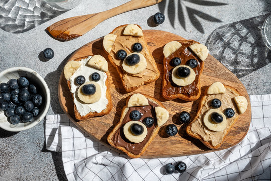Funny children bear toasts with nuts butters