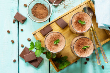 Homemade chocolate-nut mousse on the kitchen wooden background. Free space for your text. Top view flat lay background.