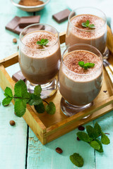Homemade chocolate-nut mousse on the kitchen wooden background. Free space for your text.