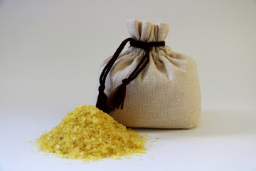 Sea yellow salt in a bag. Isolated. A bag of sea salt produced on a farm