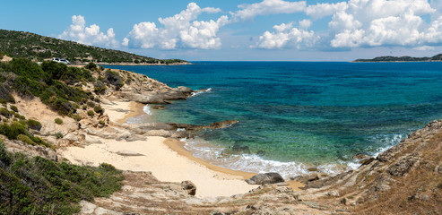 Landscape with beach, the sea and the clouds in the blue sky