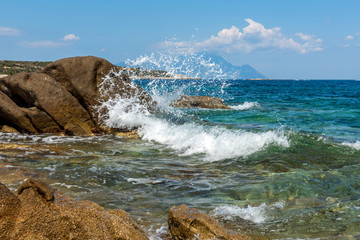 Landscape with sea, the rock and the beautiful clouds in the blue sky