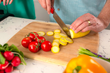 Close up of home cooking cutting board with tomatoes, squash zucchini, vegetarian meal