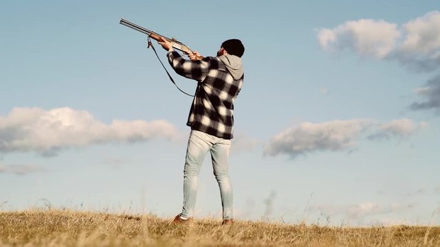 Man hunter with a gun. Sporting clay and skeet shooting. Small game. Hunter with a shotgun in a vintage shooting clothing.