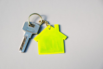 House key with home symbol on chain