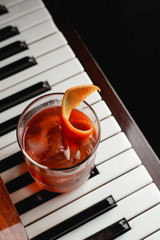 A glass of classic cocktail Negroni, based on campari gin, red vermouth, orange and homemade bitter...