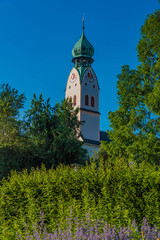 Fototapeta na wymiar Riedergarten Rosenheim mit Blick auf Kirchturm Stadtpfarrkirche Sankt Nikolaus