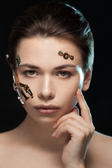 Obraz premium Portrait of a beautiful woman's face with half human face and half face robot.