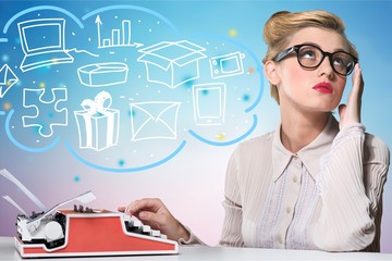 Attractive young woman working on vintage typewriter on  background