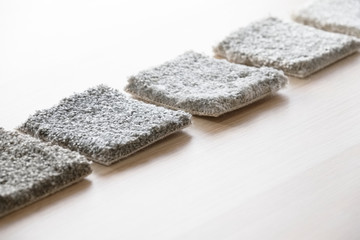 Carpet grey samples square comparison in a row on table 