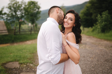 Beautiful wedding couple in Carpathian mountains. Handsome man with attractive woman