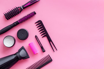 professional accessories of hairdresser with combs on work desk pink background top view copyspace