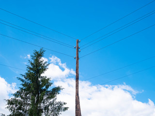 Obraz premium Power line support. Wooden Telegraph pole against the blue sky.