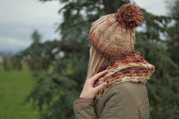 Portrait of beautiful blond girl in wool hat at cold weather