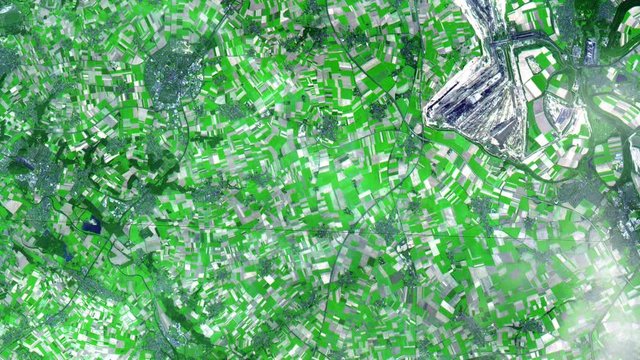 Satellite view aerial of agricultural fields pattern and big open cast mines in North Rhine Westphalia region, Deutschland. Contains public domain image by Nasa