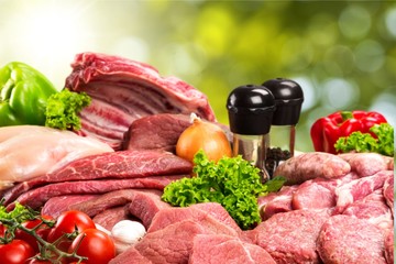 Raw Meat slices and knife on cutting board