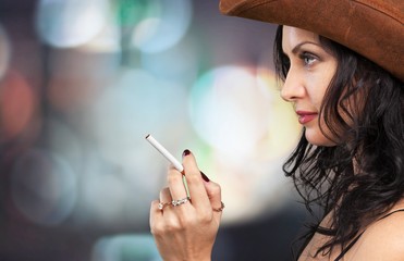 Obraz premium Portrait of the young elegant girl smoking cigarette isolated