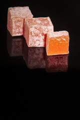 lokum Turkish delight, sweets on a black background (dessert sweets). food background. top view. copy space