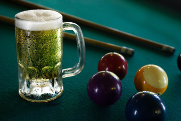 a frozen beer mug on a green billiard table, frozen, cold beer