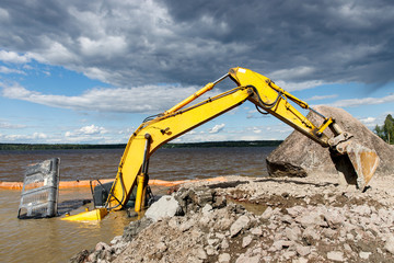 Excavator(construction equipment) drowned on the lake while working to strengthen the shore. Safety...