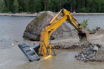 Excavator(construction equipment) drowned on the lake while working to strengthen the shore. Safety...