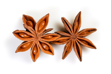 Star anise. Two star anise fruits. Macro close up Isolated on white background with shadow, top view of chinese badiane spice or Illicium verum.