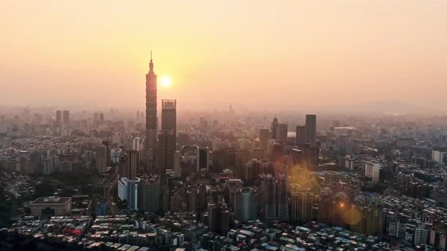 Drone video flying over Ho Chi Minh City skyline and skyscraper in center of heart business at Ho Chi Minh City downtown. Finish sun flare
