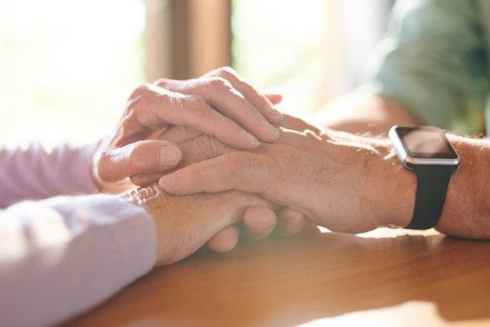 Pile Of Hands Of Contemporary Supportive Senior Husband And Wife