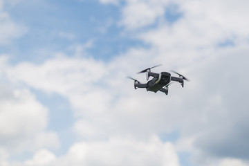 Flying drone against the sky with clouds.
