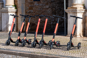 Electric scooters in row on the street.
