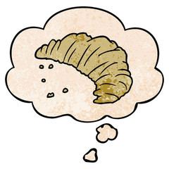 cartoon croissant and thought bubble in grunge texture pattern style