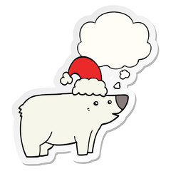 cartoon bear wearing christmas hat and thought bubble as a printed sticker