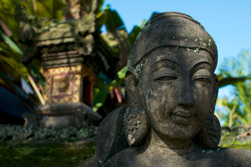Fototapeta na wymiar Close up picture of a female like stone statue in Bali