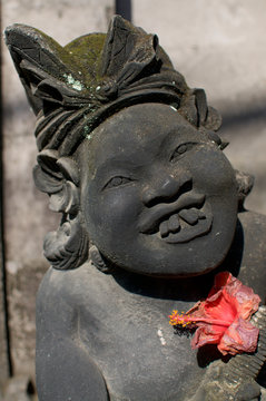 Close up of a bizarre balinese stone statue