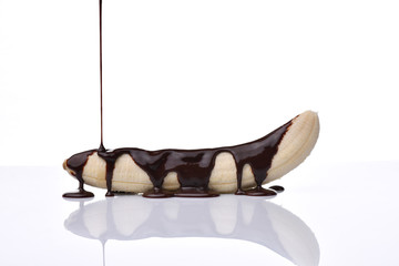 temptation concept - banana with chocolate on a white