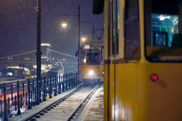 Tramway carriage on snow covered railway track at night
