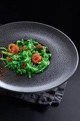 Chuk salad on a black plate