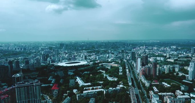 drone hyperlapse: stadium in a green city, a terrible sky and the sun's rays. Kyiv, Ukraine  - Cityscape Aerial Flight