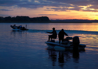 Silhouetted Fisherman Heading Out to Fish as the Sun Comes Up in a Beautiful Sunrise