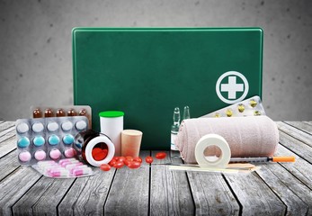 First aid kit  with medical supplies on light background