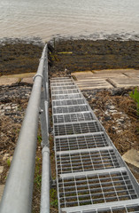 steel steps going out to see, leading lies photo on essex coast near bradwell