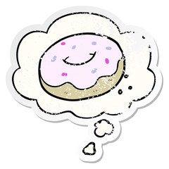 cartoon donut and thought bubble as a distressed worn sticker