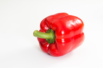 Red Bell Pepper with stem on a white background. - 274997624