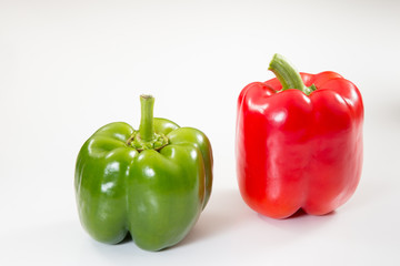 Reg and Green bell peppers on a white background. - 274997663