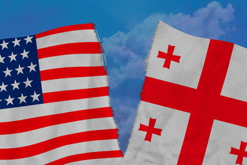 two national flags of america and georgia are torn apart by fabric, close-up, concept of diplomatic break, political and economic relations between countries