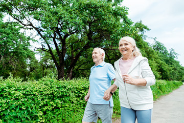 happy senior woman running near husband in park © LIGHTFIELD STUDIOS