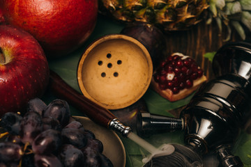 Obraz na płótnie Canvas fresh tasty fruits and hookah on wooden surface