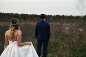 bride and groom in field 