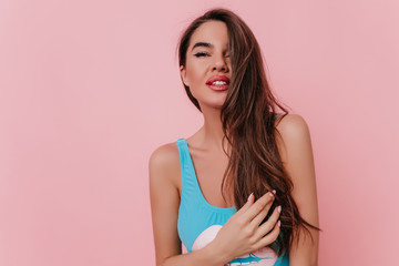 Sensual long-haired caucasian girl looking to camera. Indoor portrait of blissful brunette woman...
