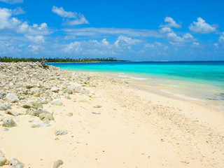 Coral beach, anchorage and cruising sailboats at Cocos Keeling Islands, Indian Ocean, Australia.